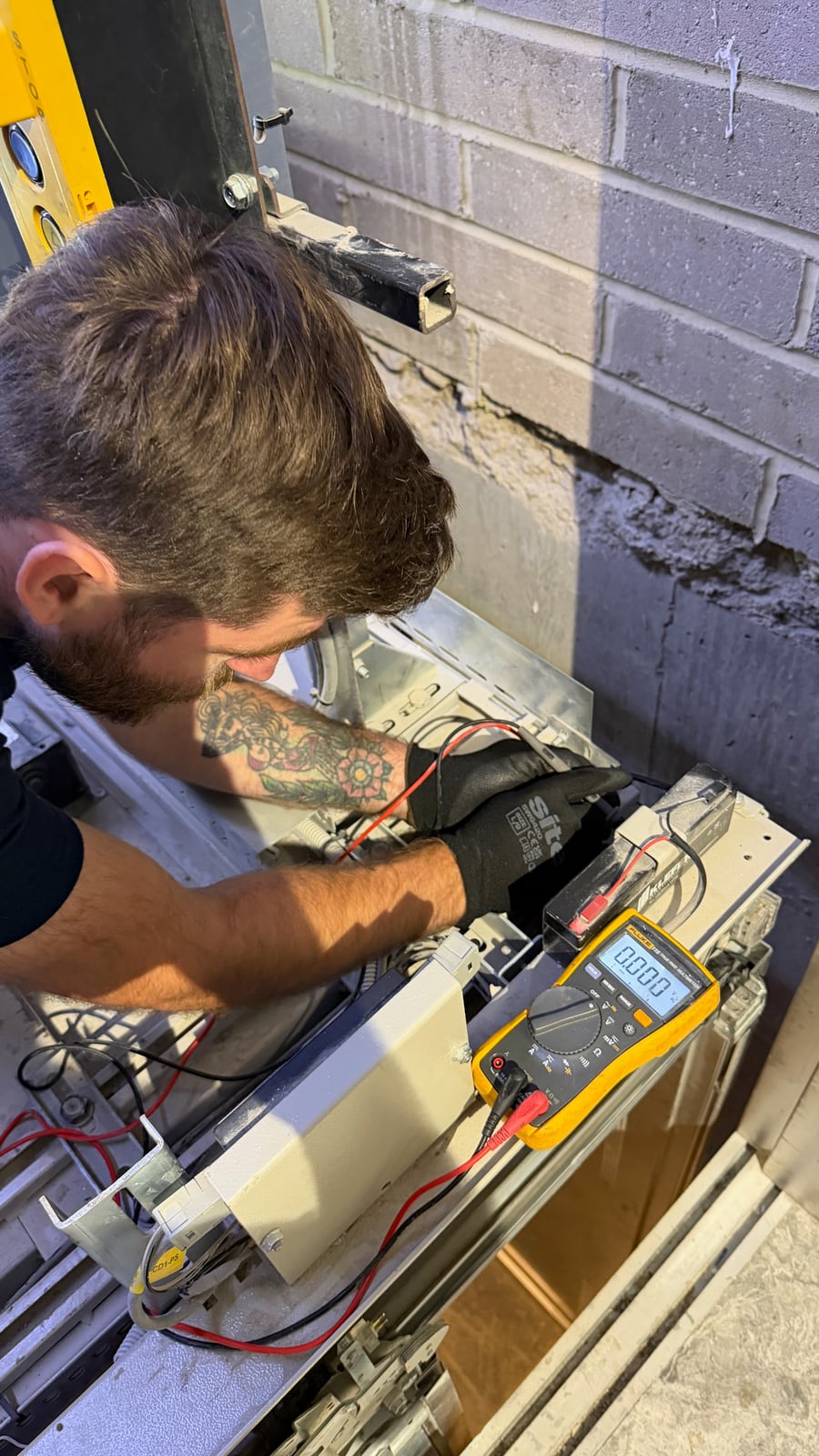 Engineer carrying out electrical checks on lift equipment