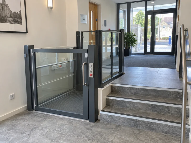 Vertical platform lift beside steps for step-free access