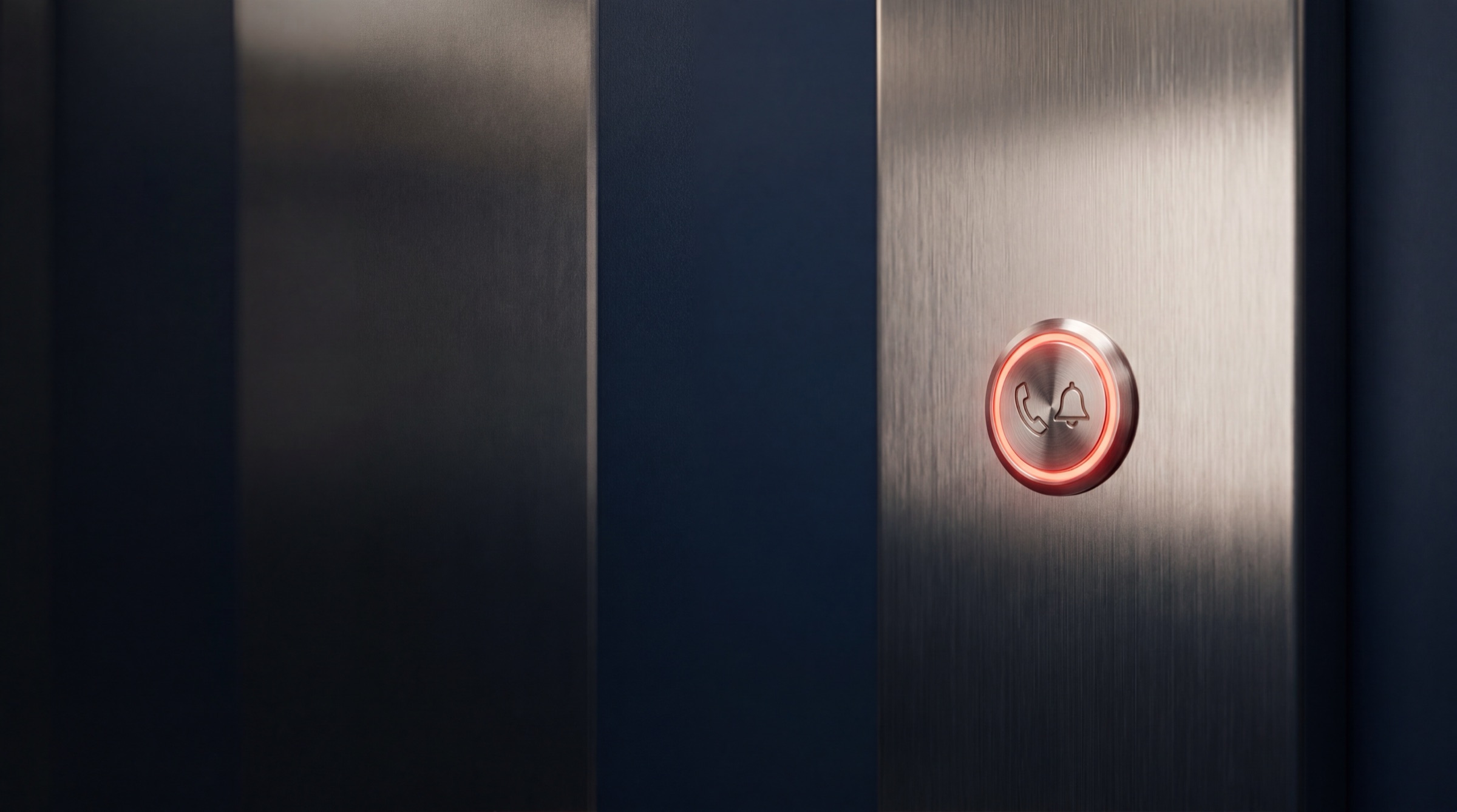Illuminated lift emergency call button engraved with a phone and bell symbol
