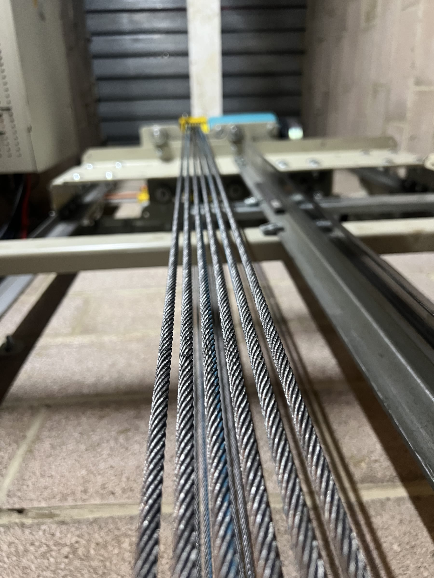 Steel traction ropes inside a lift shaft during a LOLER examination