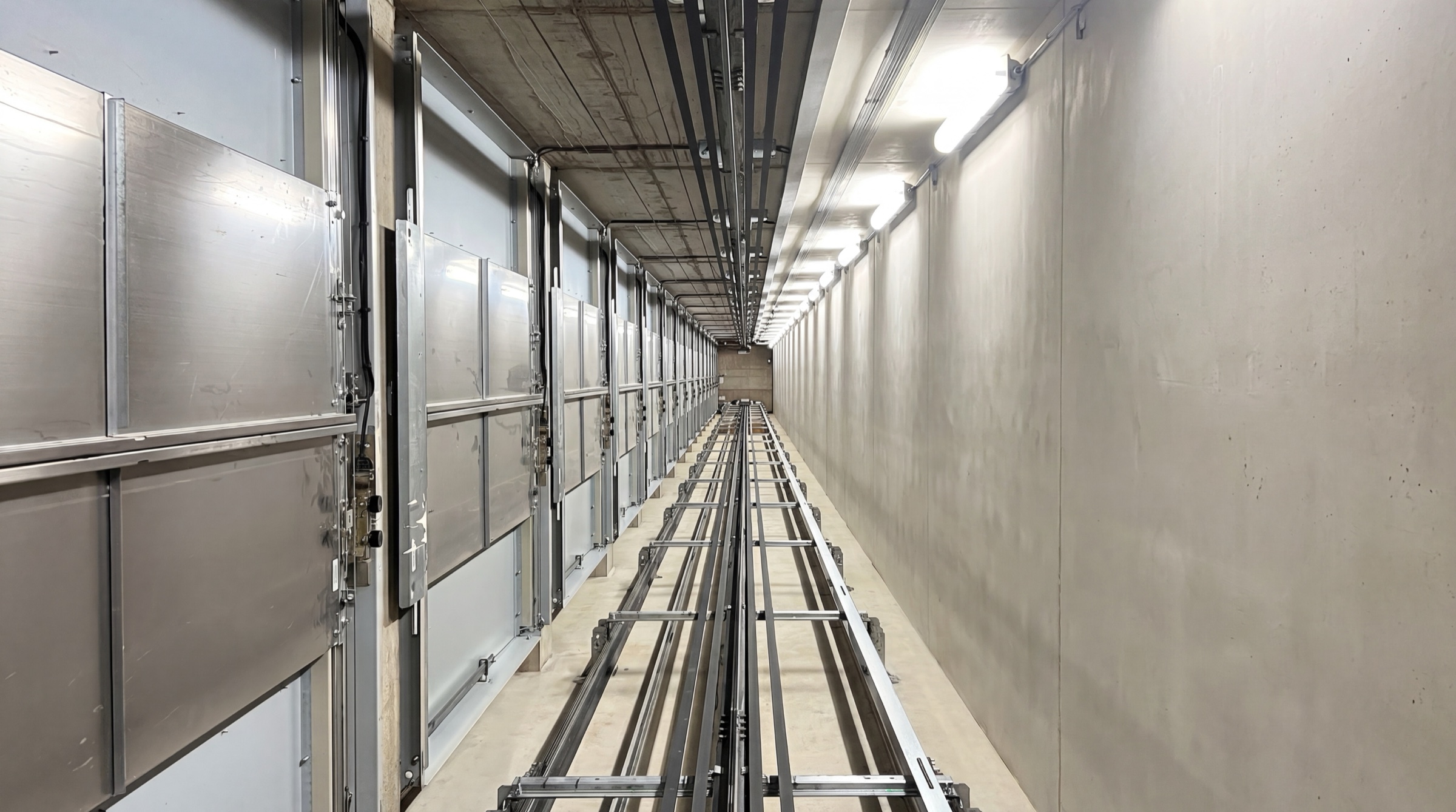 Lift engineer carrying out a car-top inspection at the control station inside a lift shaft